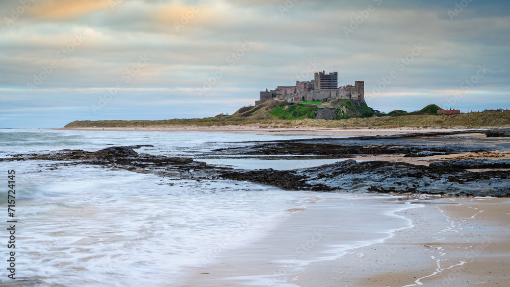 Harkess Rocks below Bamburgh Castle.  Miles of a sandy beach end at Harkess Rocks on the shoreline of the North Sea at Bamburgh in Northumberland, England
