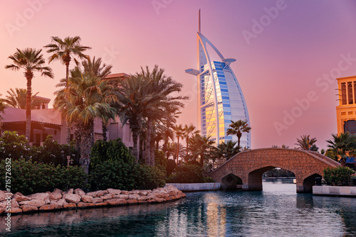 Dubai seaside skyline modern skyscraper luxury hotel on beach with palms, sunset light. Famous tourist landmark of UAE.