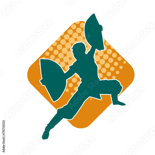 Silhouette of a slim female doing martial art pose. Silhouette of a martial art woman in action pose.