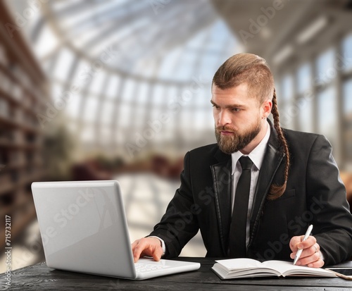 Smiling young businessman working in office © BillionPhotos.com