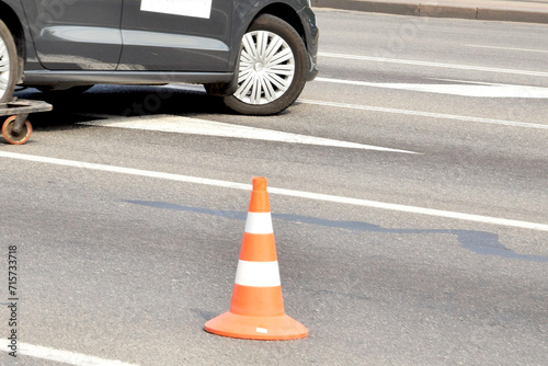 Emergency driving. An orange cone stands on the asphalt
