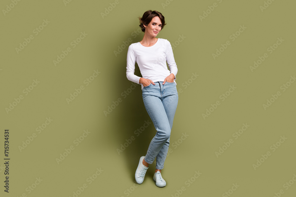 Full length photo of attractive young model lady posing advertising new clothes shopping isolated khaki green color background Full length photo of attractive young model lady posing advertising new clothes shopping isolated khaki green color background