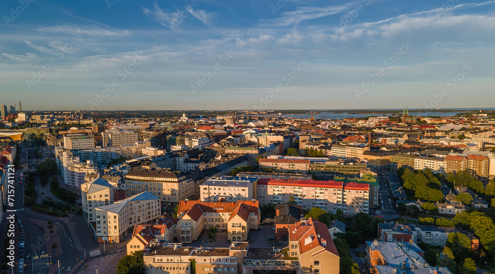 Aerial close view to Helsinki central residental area. Multistory buildings. Colorful roofs in Scandinavia. Finland sunset