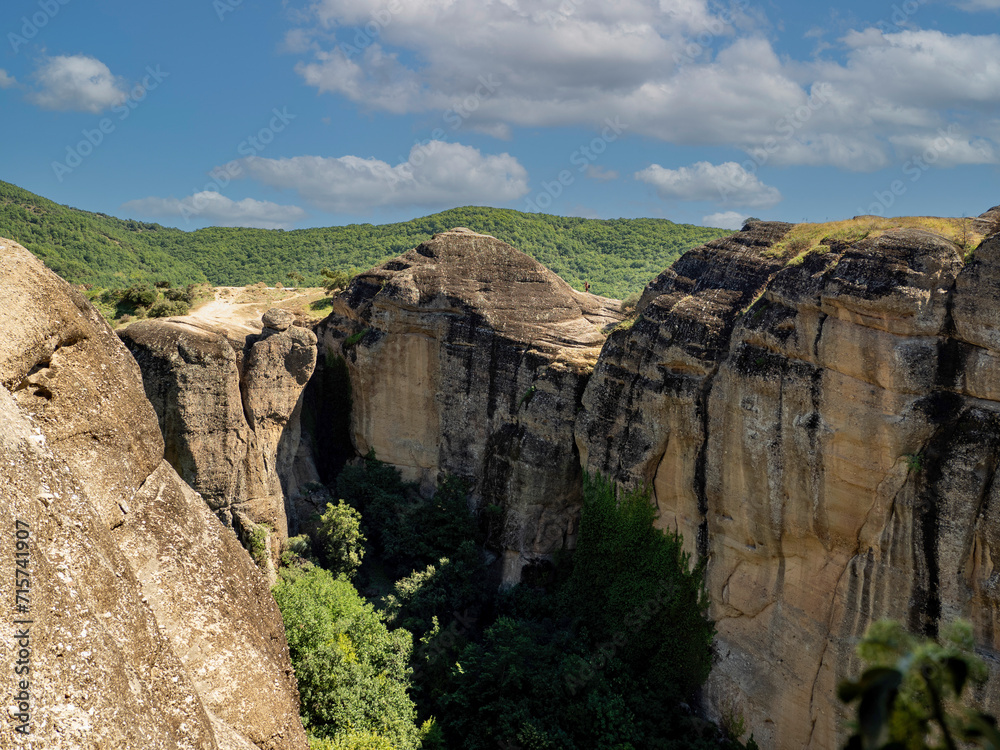 Panoramic view of Meteora monastery on the high rock and road in the mountains, Greece Panoramic view of Meteora monastery on the high rock and road in the mountains, Greece