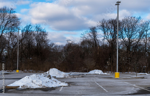 Piles of cleared snow in a parking lot in Edgewood, Pennsylvania, USA on a sunny winter day