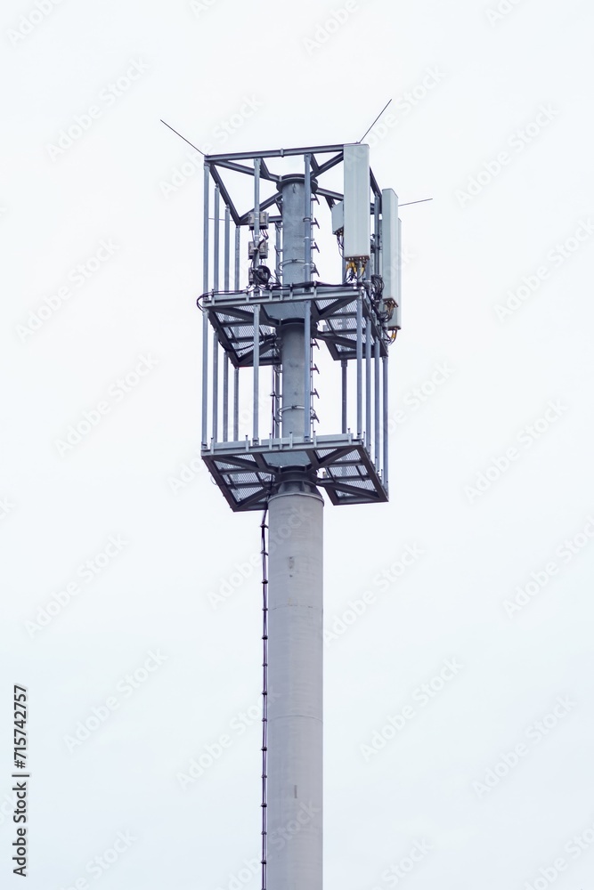 modern mobile radio tower with grey sky