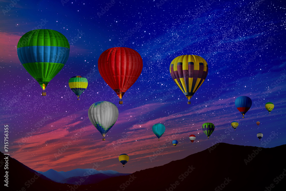 Bright hot air balloons flying in starry sky over mountain