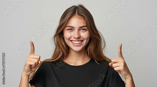 Portrait of an American woman in black t shirt indicating  two forefingers up in a clean backdrop with copy space, Generative AI. photo