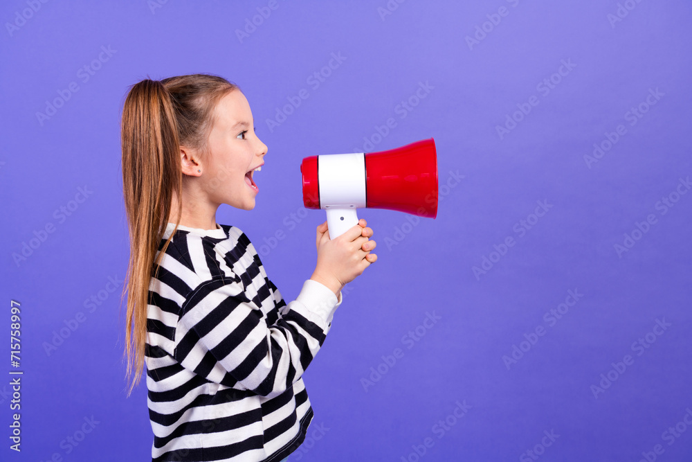 Photo of sweet cheerful small kid wear striped sweater screaming toa empty space isolated violet color background Photo of sweet cheerful small kid wear striped sweater screaming toa empty space isolated violet color background