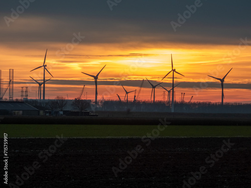 Wind turbines and industrial zone at sunset, Vlissingen-Oost, Netherlands photo