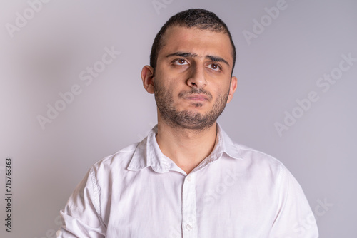 An isolated image of a confused and upset twenty two year old man.