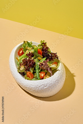 Salad with asparagus on a bright background.