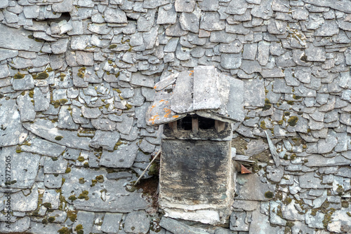 old chimney at a house with old slate roof in Caspoggio in Region Valmalenco