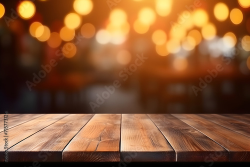 Empty wooden table and blurred background of bar or pub. For product display.