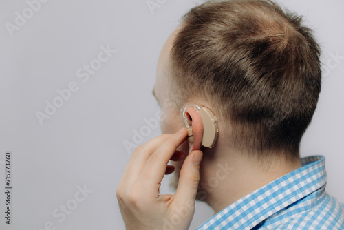 man with a hearing aid on a white background in a shirt without a face photo