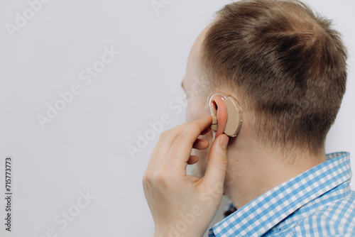 man with a hearing aid on a white background in a shirt without a face photo