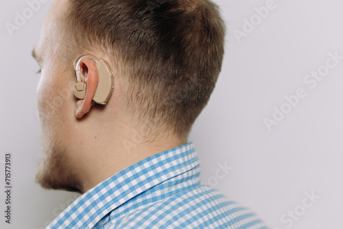 man with a hearing aid on a white background in a shirt without a face photo