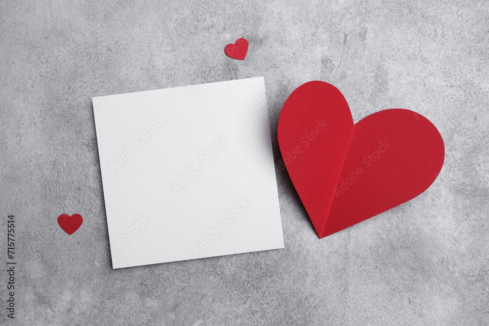 Blank square valentines card or flyer mockup, flat lay with red hearts decor, copy space Blank square valentines card or flyer mockup, flat lay with red hearts decor, copy space