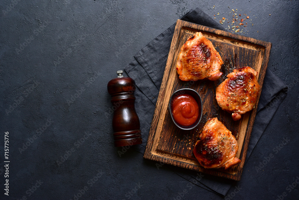 Roasted chicken thighs with ketchup. Top view with copy space. - obrazy, fototapety, plakaty 