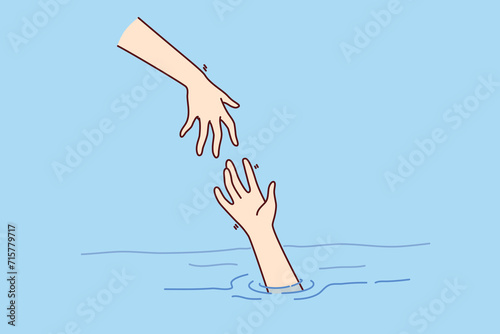 Savior hand helps drowning man get out of water, for concept getting into trouble and importance of helping those in need. Drowning person raises palm as metaphor for business bankruptcy or job loss