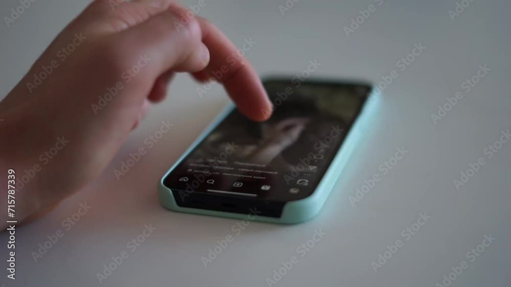 scrolls through the feed on the phone scrolls through the feed on the phone