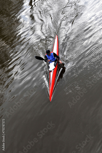 Sportsman in kayak sails river. Extreme sport rafting. Aerial top view