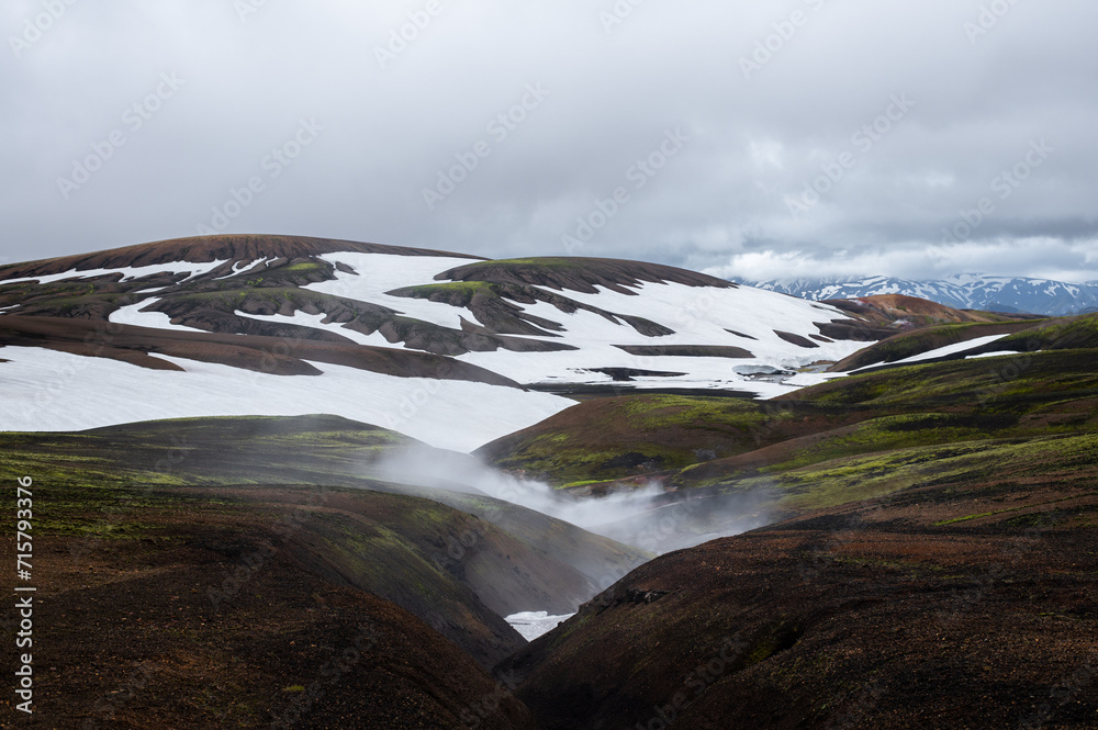 The picturesque Icelandic landscape of rainbow volcanic rhyolite mountains and fumaroles in the geothermal volcano area on Icelandic highlands at Landmannalaugar, Iceland. Laugavegur hiking trail.
