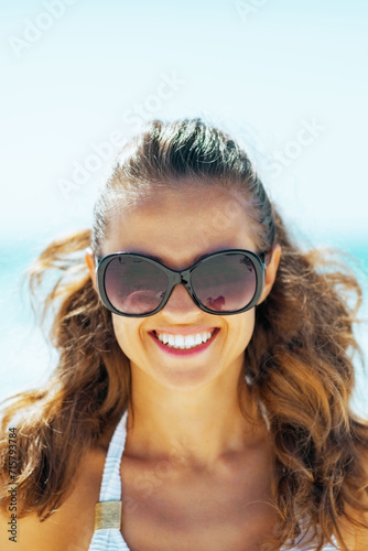 young woman in sunglasses on beach