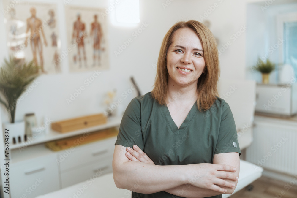 smiling female medical massage therapist looking at camera smiling female medical massage therapist looking at camera