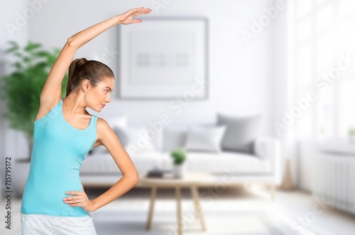 Young happy woman do yoga in living room