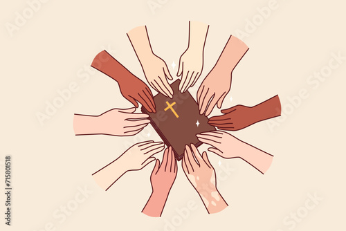 Christian bible in hands of multiracial people, respect catholic religion and want to learn prayers. Multiethnic church parishioners reach for bible with cross on cover, following word of god photo