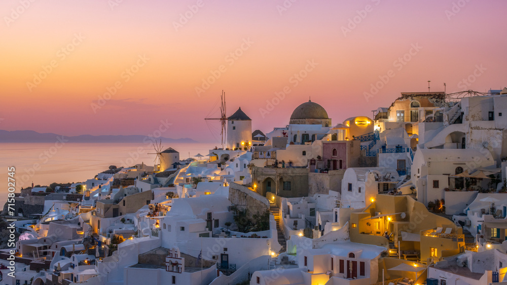 Sunset in the Greek village of Oia Santorini with a view of the caldera in the sea, Greece 