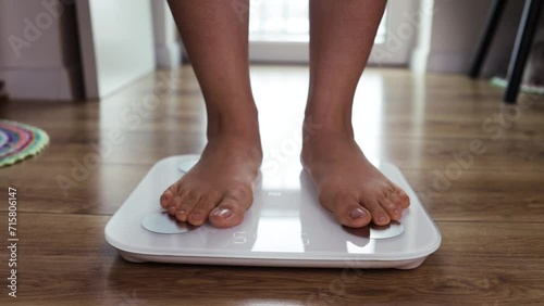 Weight Lose Scales Measure Weight. Girl Legs Step Bathroom Scale. Fitness Diet Woman Feet Standing Weighing Scales Slimming. Dieting Checking BMI Weight Loss. Barefoot Measuring Body Fat Overweight photo