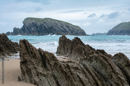 Panoramic of Arnía beach and Canales de los Urros with rock formations at low tide in a cloudy weather in Costa Quebrada near Santander, Cantabria, North Spain.
