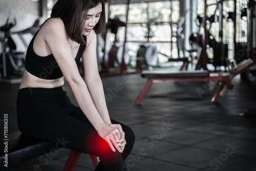 Asian slim woman play fitness at the gym,She pain from exercise © reewungjunerr