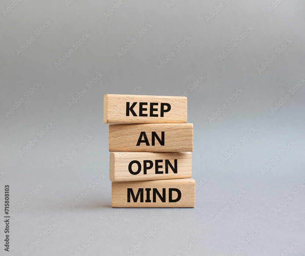 Keep an open mind symbol. Wooden blocks with words Keep an open mind. Beautiful grey background. Business and Keep an open mind concept. Copy space.