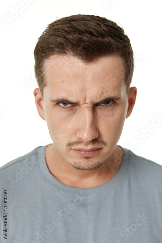 annoyed angry man standing on white studio background