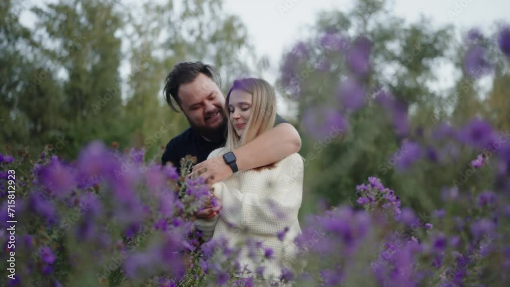 Couple man and woman spending time together, walking on meadow, embracing and kissing. Happy joyful male and female have fun at romantic date outdoors. Couple man and woman spending time together, walking on meadow, embracing and kissing. Happy joyful male and female have fun at romantic date outdoors.
