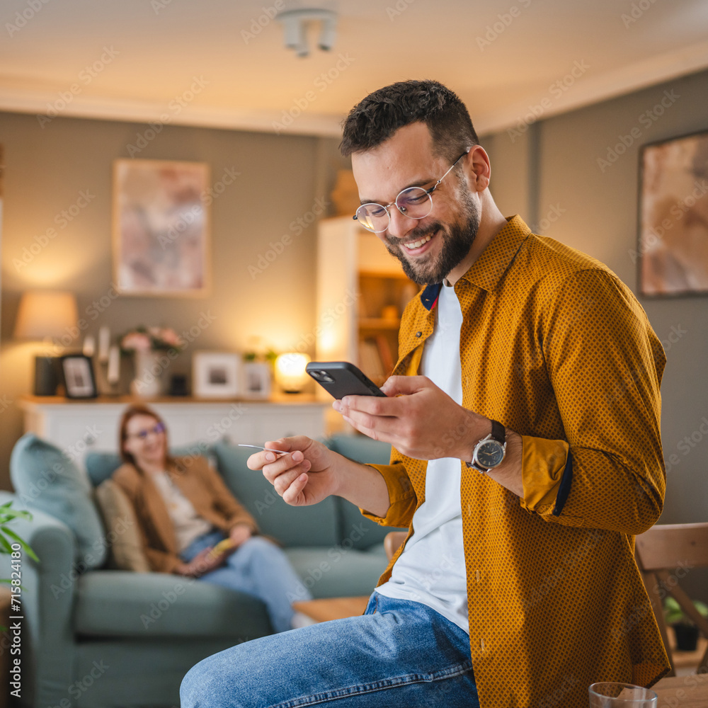 © Miljan Živković - online shopping man hold credit or debit card make online purchase