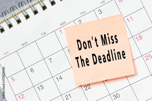 Dont miss the deadline text on sticky note on a calendar. photo
