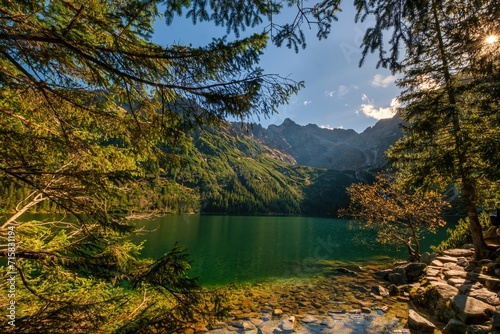 Beautiful, colorful mountain lake with an azure surface and mountain peaks with beautiful sunlight. Morskie Oko - Eye of the Sea - Tatry - Tatra Mountains.Polska Most beautiful places in Poland Polska