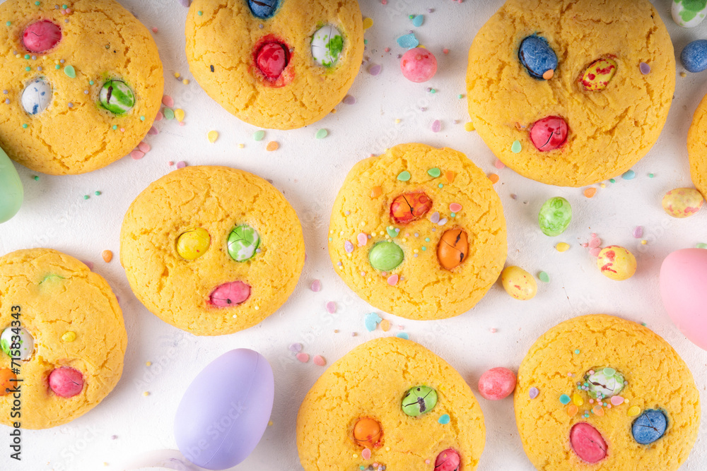 Colorful Funfetti chocolate chips mix Cookies. Homemade sweet Easter vanilla biscuits with sugar sprinkles and chocolate Easter eggs, on white kitchen table background, with holiday decor Colorful Funfetti chocolate chips mix Cookies. Homemade sweet Easter vanilla biscuits with sugar sprinkles and chocolate Easter eggs, on white kitchen table background, with holiday decor