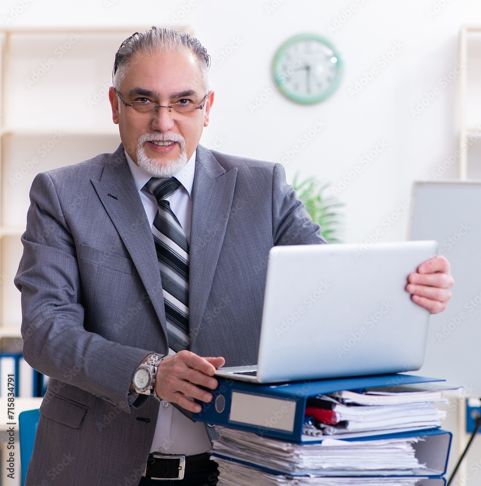 Aged male employee unhappy with excessive work Aged male employee unhappy with excessive work