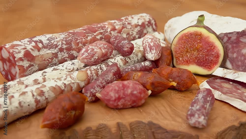 Jerked sausages and figs on a wooden board Jerked sausages and figs on a wooden board