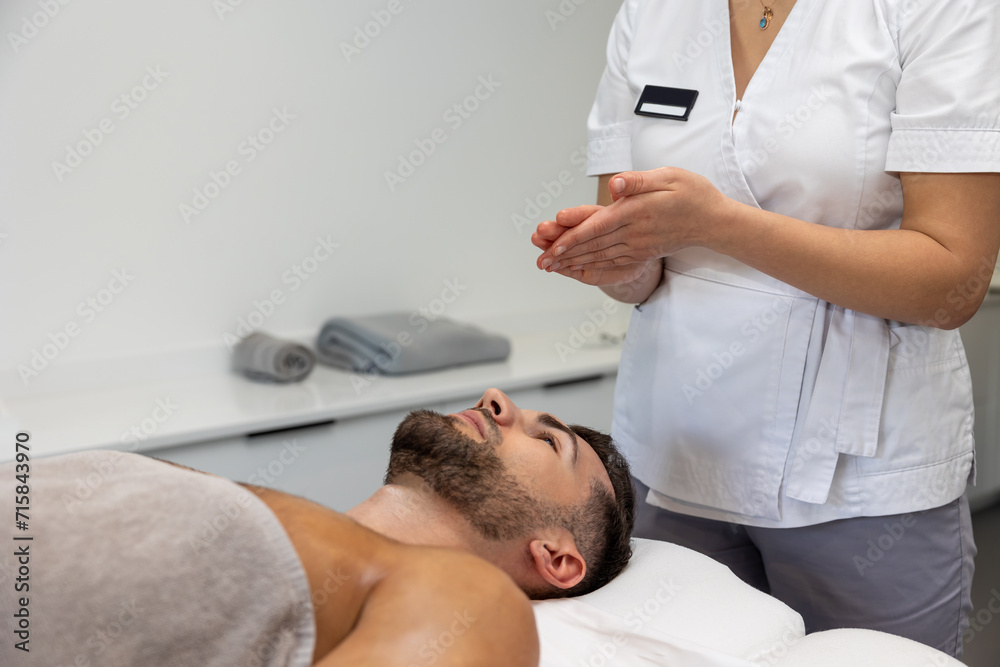 Fototapeta premium Young man having relaxing procedures in a massage salon