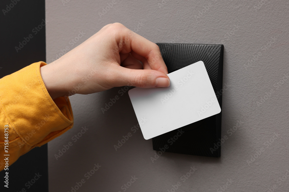 Woman opening magnetic door lock with key card, closeup. Home security Woman opening magnetic door lock with key card, closeup. Home security