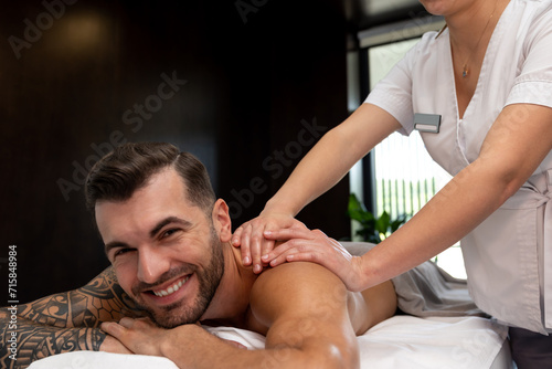 Man having back massage session and looking contented