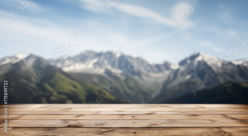 Empty wooden deck table with a blurry majestic mountain landscape in the background, concept of nature.