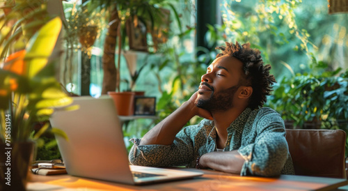 a man is resting his head while working at home
