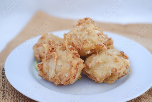 Bakwan sayur or vegetable fritter, Indonesian snack made from flour, cabbage, carrots and bean sprouts, served with chili